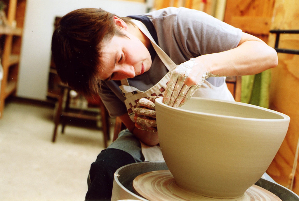 Linda Bloomfield: potter, designer, author, teacher and an expert on ceramic glazes, shown here throwing  a pot on the wheel
