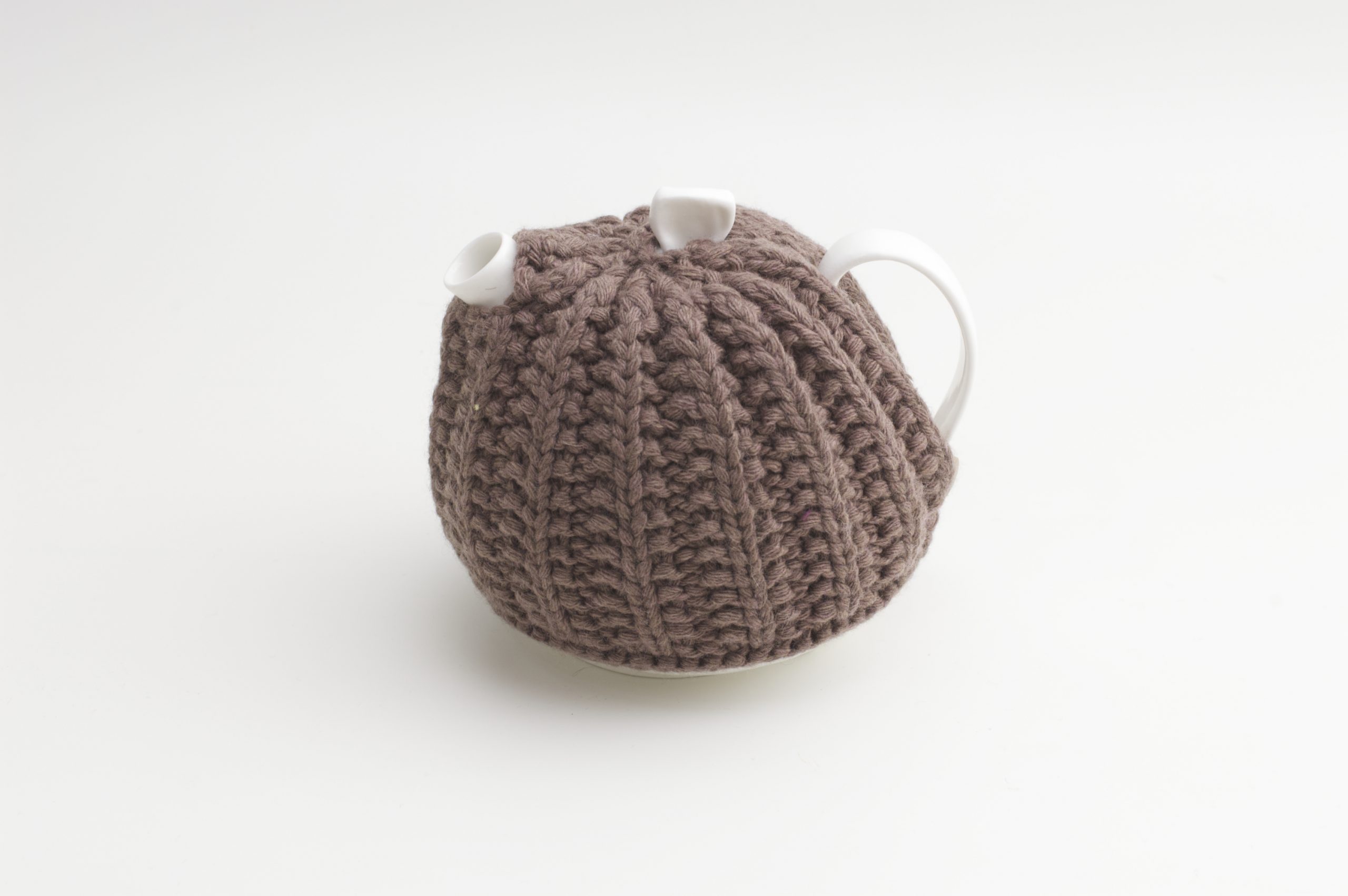 Bone China Teapot designed by Linda Bloomfield, with brown knitted cosy by Ruth Cross