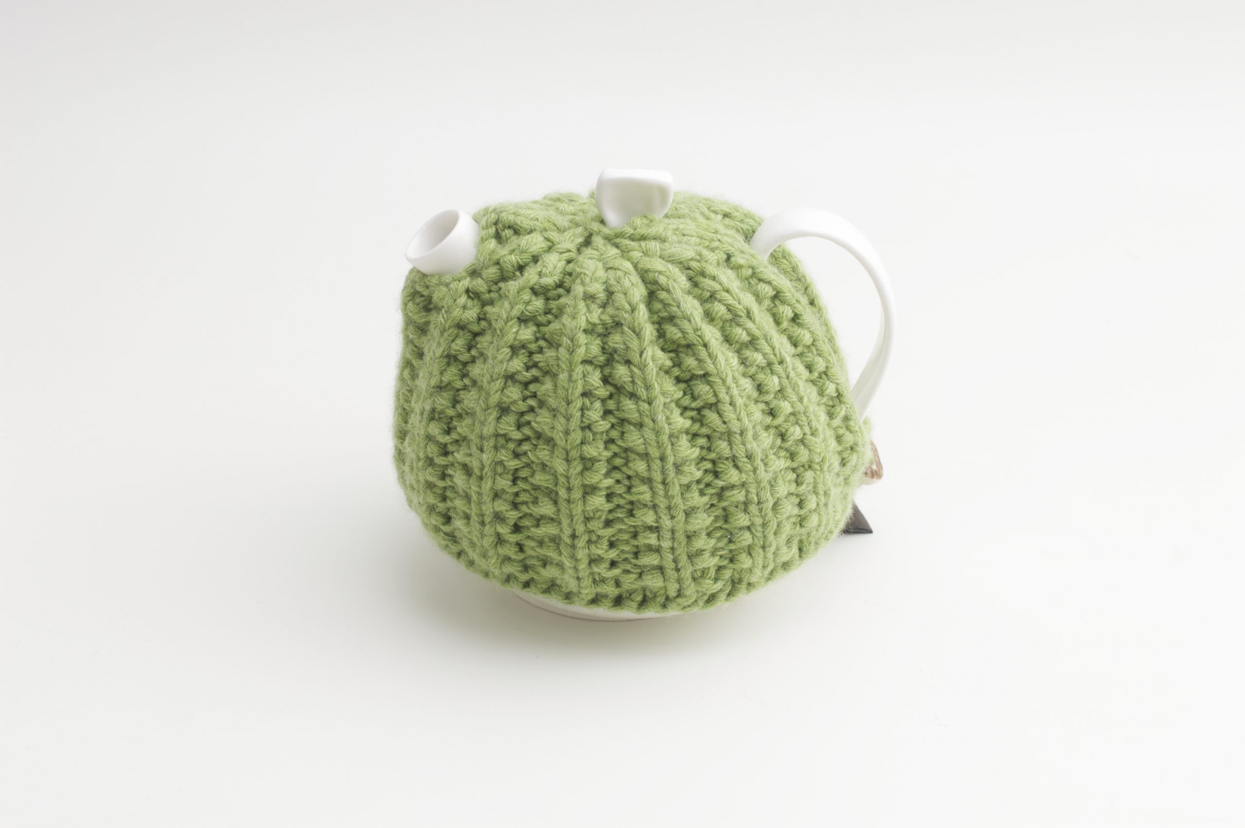Bone China Teapot designed by Linda Bloomfield, with green knitted cosy by Ruth Cross